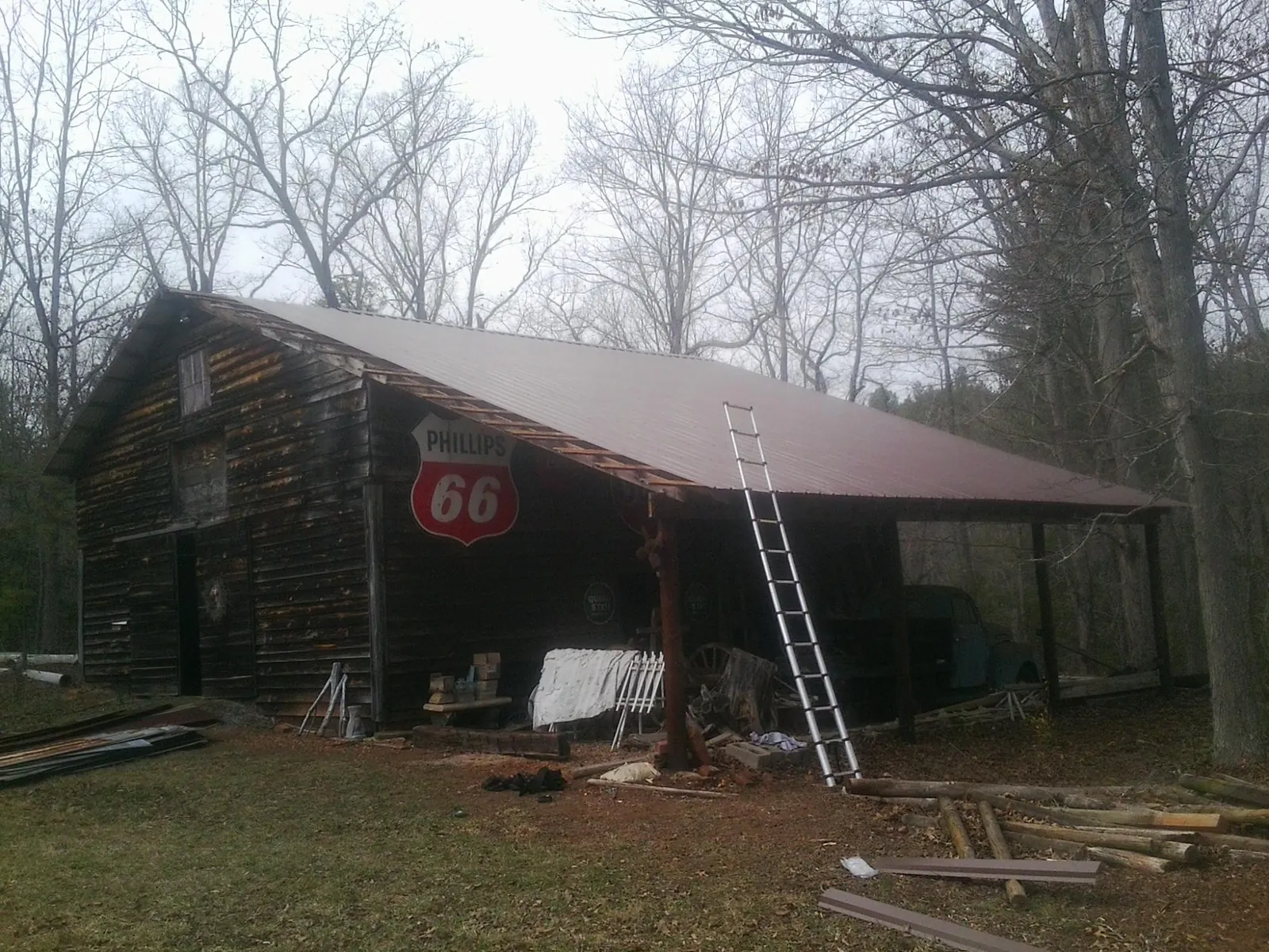 New metal roof on an open sided timber barn with a vintage sign in Claremont